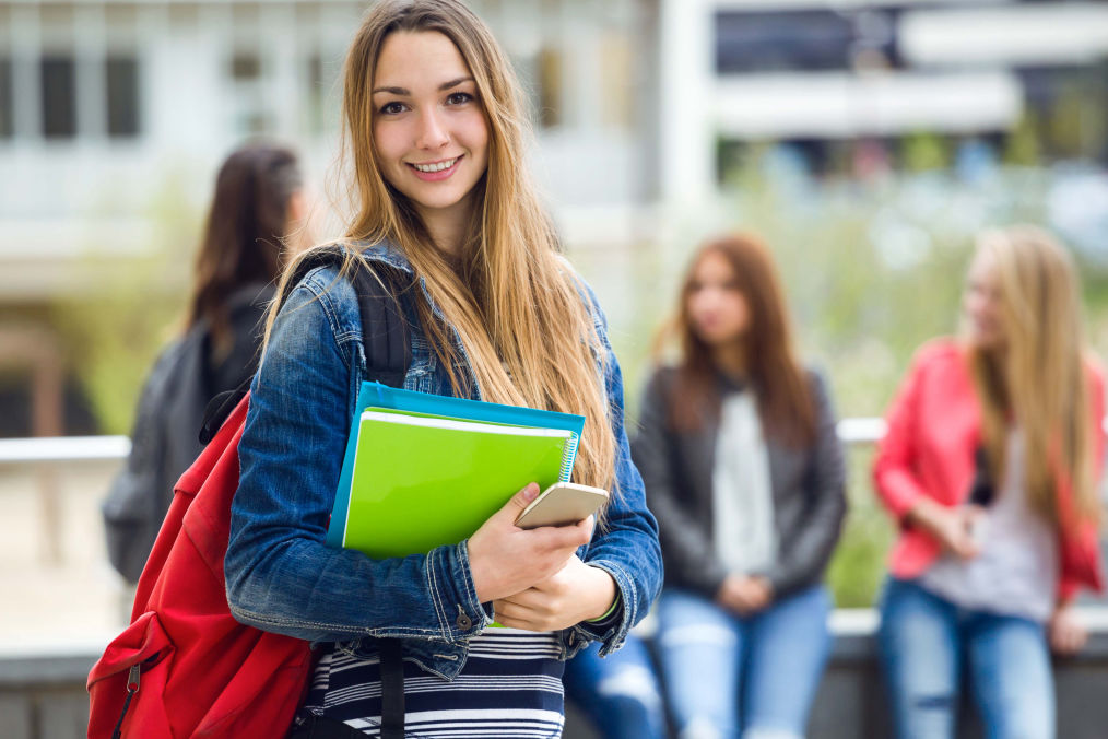 Image of a girl carrying her books